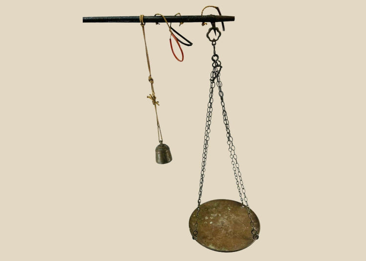 Antique Indian steelyard balance scale, circa 18th–19th century, with forged iron beam, engraved calibration notches, bronze hanging pan, and original cast bronze weight with woven cord. Traditional Mughal/Colonial trade tool with rich aged patina.