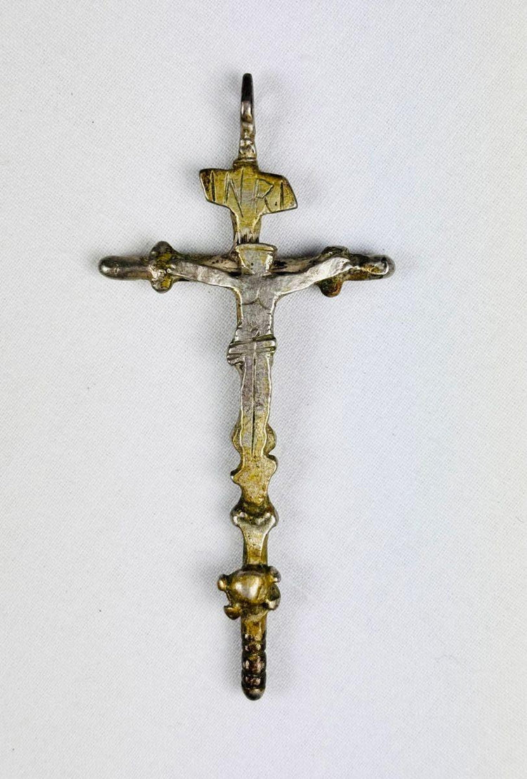 Antique silver crucifix pendant, circa 1780–1820, with sculpted Christ figure, INRI inscription, baroque-inspired detailing, and remnants of gilding. Southern European devotional piece used in Catholic ritual and personal devotion.