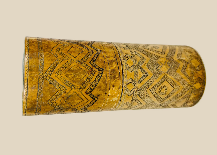 Antique carved bamboo container from Island Southeast Asia, 19th century, cylindrical with fitted lid and base, decorated with incised geometric patterns darkened with pigment, traditionally used for betel nut lime storage, photographed on a white background.