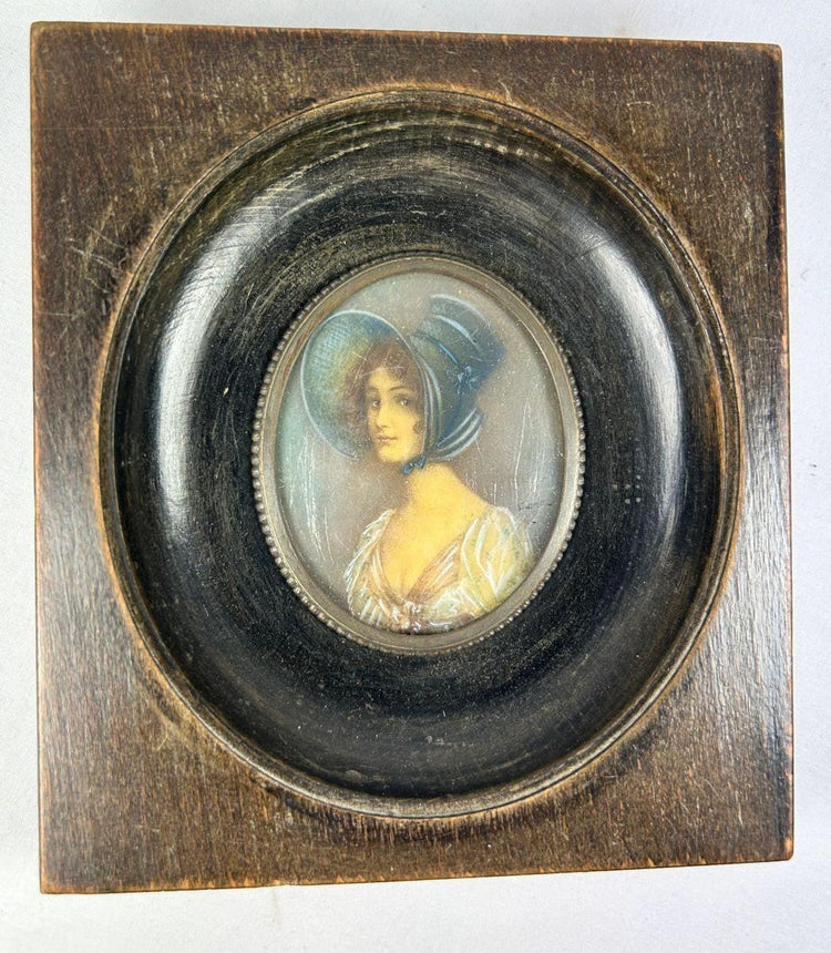 Antique 19th-century Viennese miniature portrait of a woman in blue bonnet and lace gown, painted in gouache on wafer, in original ebonized wooden frame with convex glass.