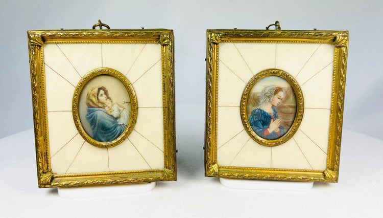 Pair of 19th century hand-painted miniature portraits in gilt frames with ivory-style panel insets. Depicting devotional female figures, one in prayer and one cradling a child. Original rectangular frames with oval portrait centers, fine detail and patina.