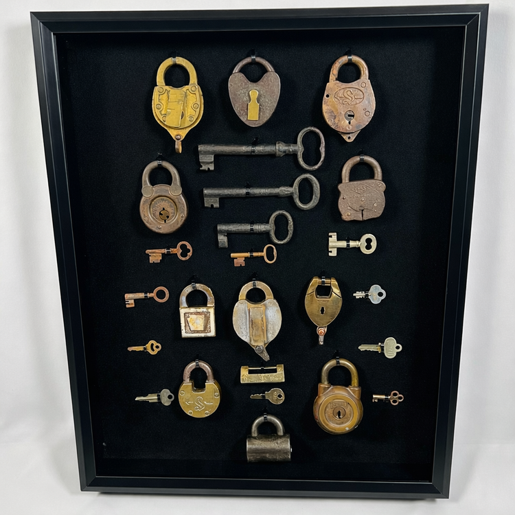 Framed antique lock and key set featuring 12 padlocks and 13 skeleton keys with aged patina