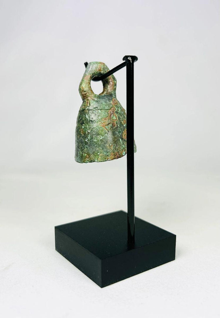 Full artifact photo of ancient Roman bell with looped handle and smooth rounded form.