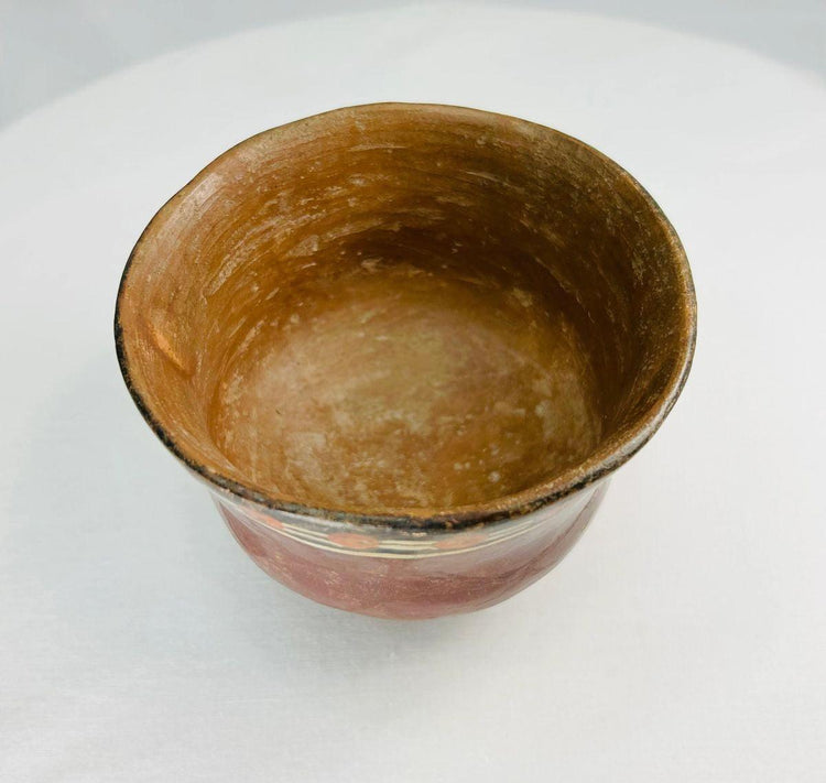 Ancient Nazca polychrome bowl from Peru with hand-painted geometric designs and rounded terracotta form, circa 100–300 AD.