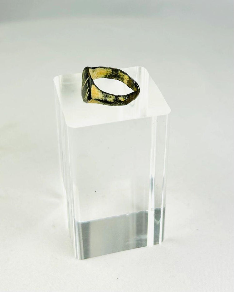 Side profile of an ancient Roman bronze ring revealing solid cast band construction
