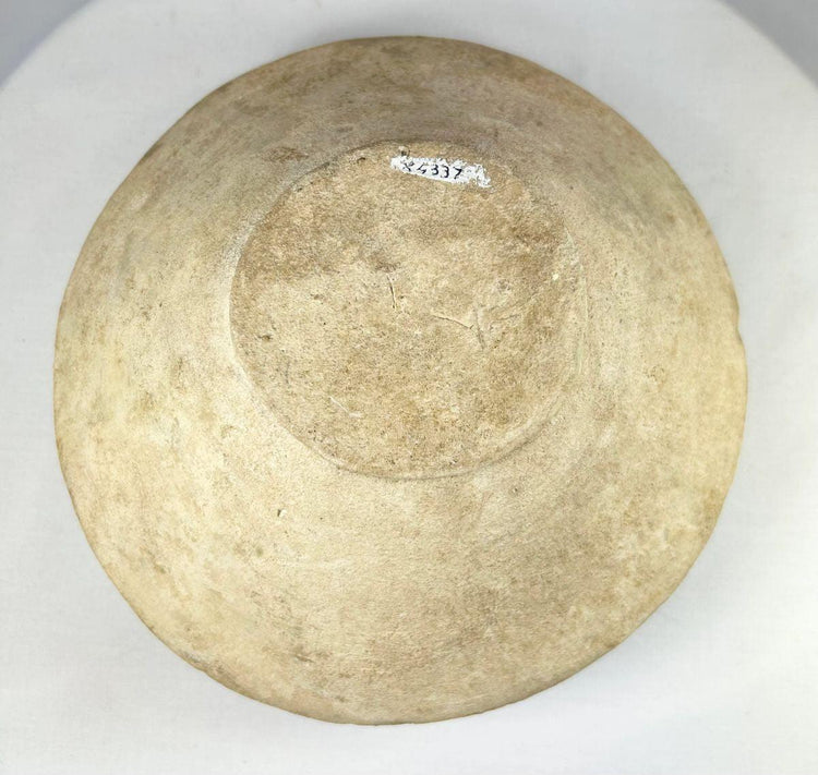 Rear view of ancient Harappan bowl showcasing detailed slip-painted fish patterns and linear motifs.