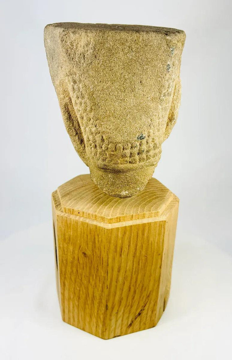 Rear angled view of Khmer Sandstone Buddha Head Fragment from 12th-Century Angkor Period Cambodia, showing detailed hair texture and sandstone weathering, mounted on wooden base – Relic and Rarity.