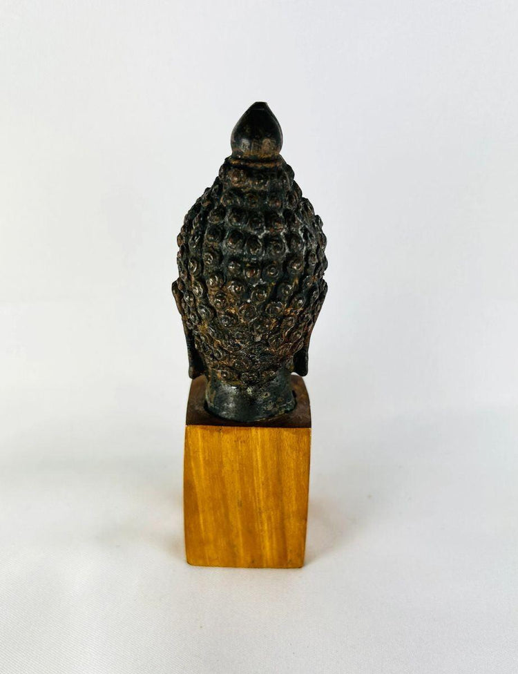 Antique bronze Buddha head 18th–19th century CE symbolizing peace and enlightenment