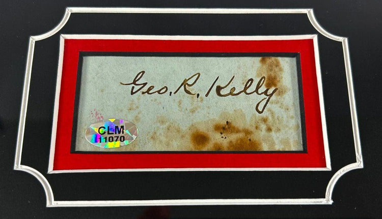 Authentic signature of George “Machine Gun Kelly” Barnes on aged paper with COA hologram, mounted in red and black archival frame, circa 1930s.