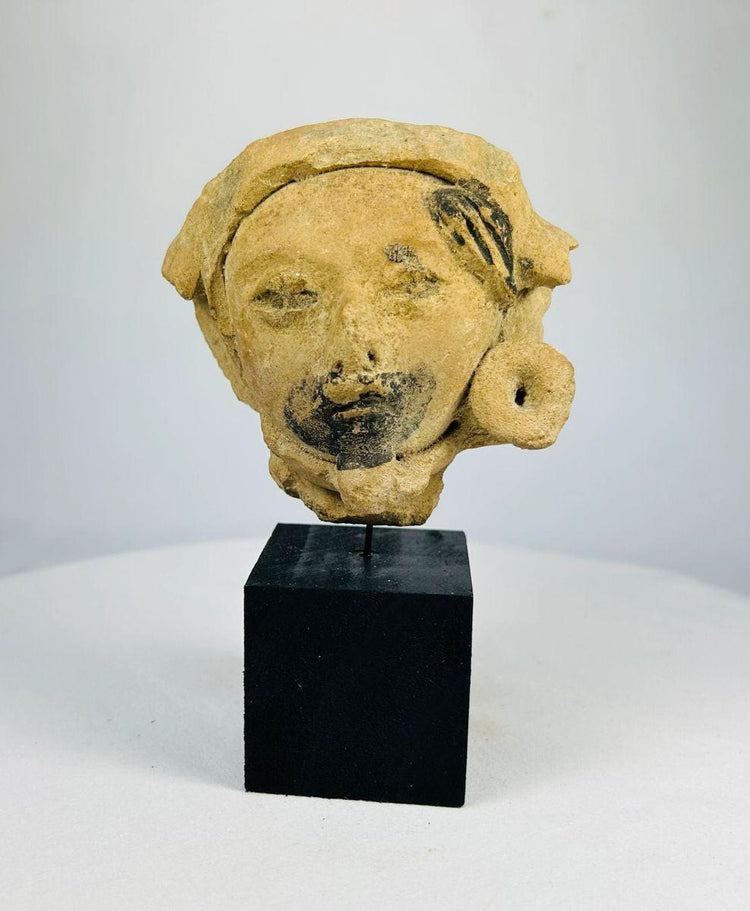 Ancient Mesoamerican ceramic fragment with headpiece and pigment remnants