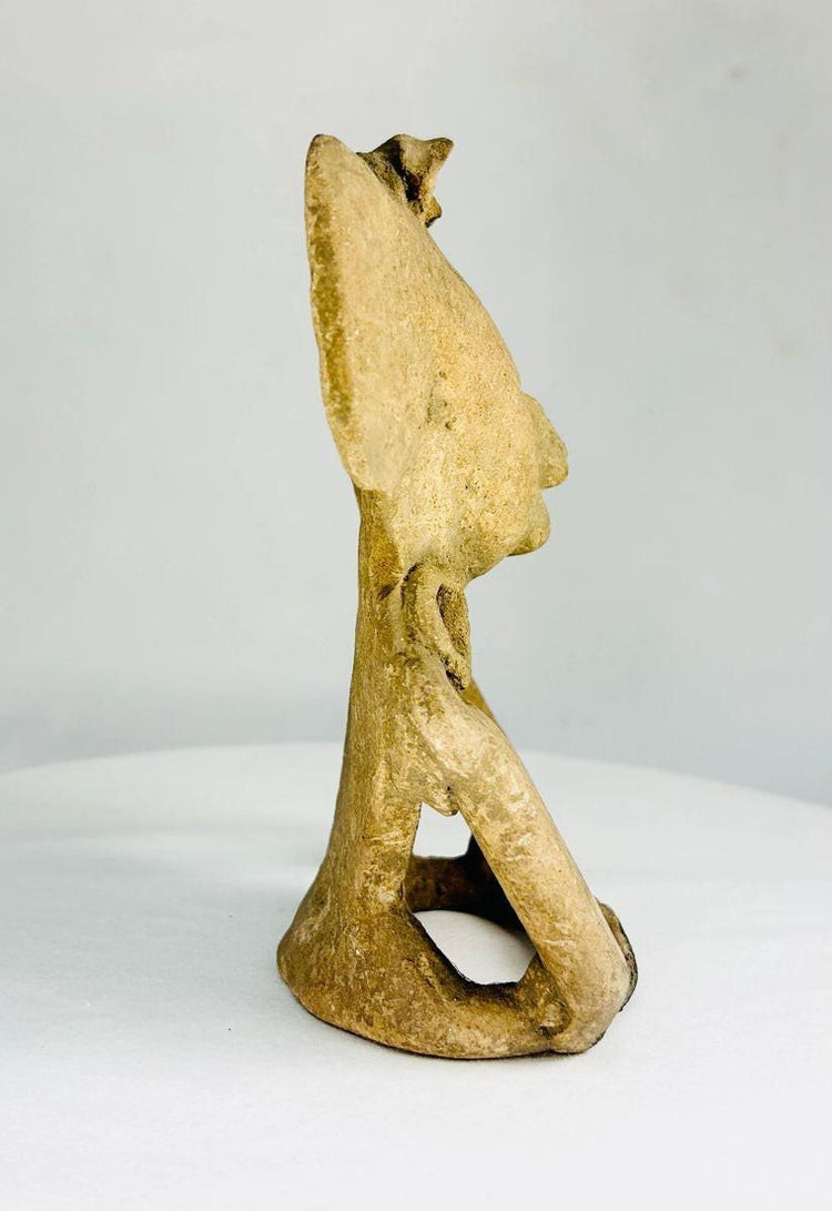 Classic Period pre-Columbian terracotta figure with large circular ear ornaments and hollow back cavity, used for ritual or ceremonial purposes