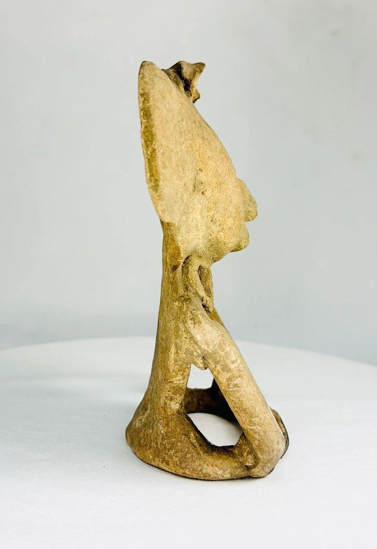 Classic Period pre-Columbian terracotta figure with large circular ear ornaments and hollow back cavity, used for ritual or ceremonial purposes