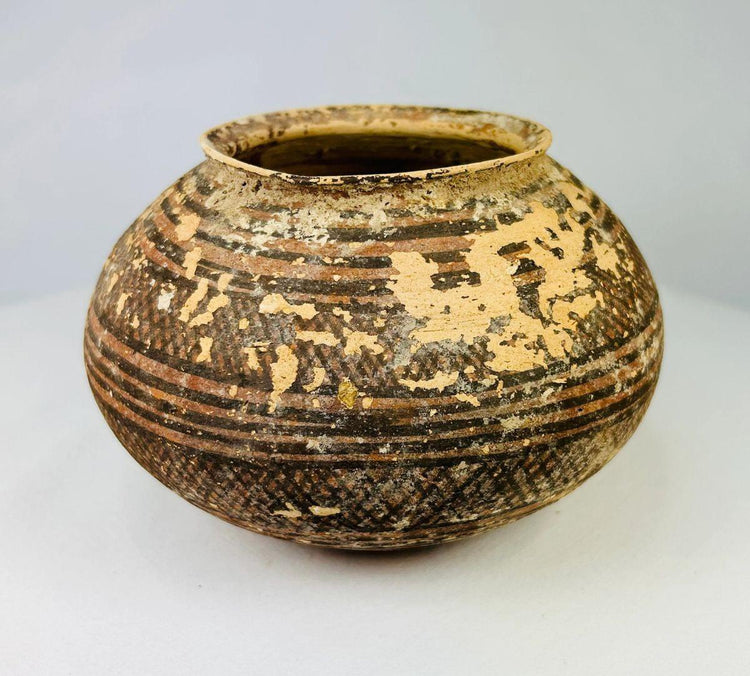 Ancient Indus Valley pottery vessel with black and red painted patterns
