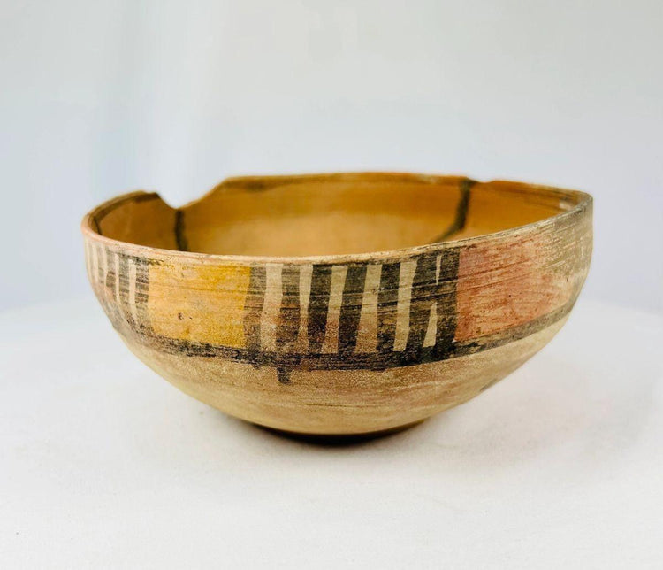 Ancient Harappan terracotta bowls showing archaeological wear and restoration