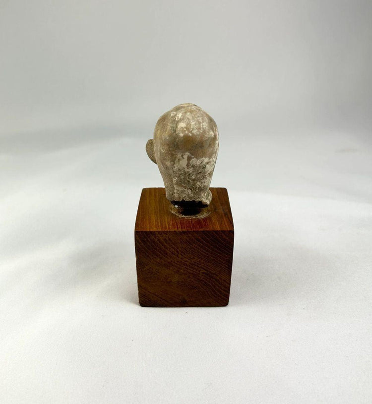 Back view of terracotta sculpture fragment showing original surface texture and age wear.