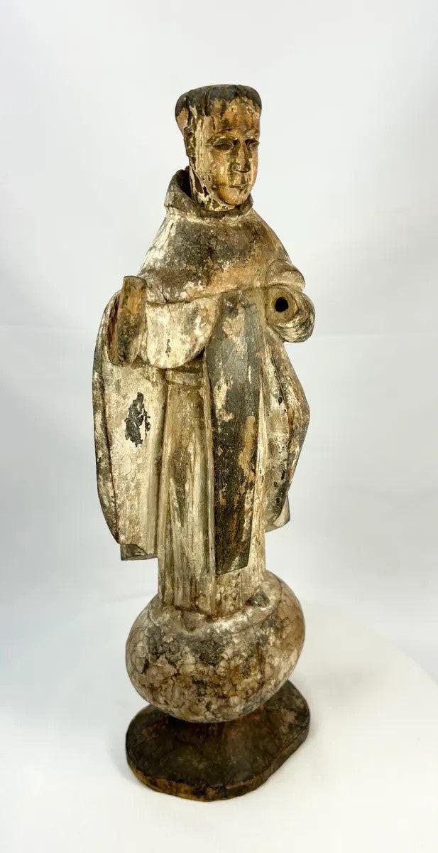 Spanish Colonial Latin American santo figure in carved wood, featuring a frontal stance and original integral base.