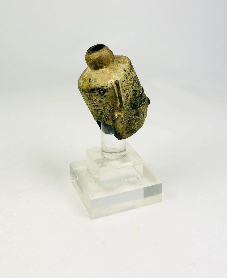 Side profile view showing facial modeling of a bronze Buddha head