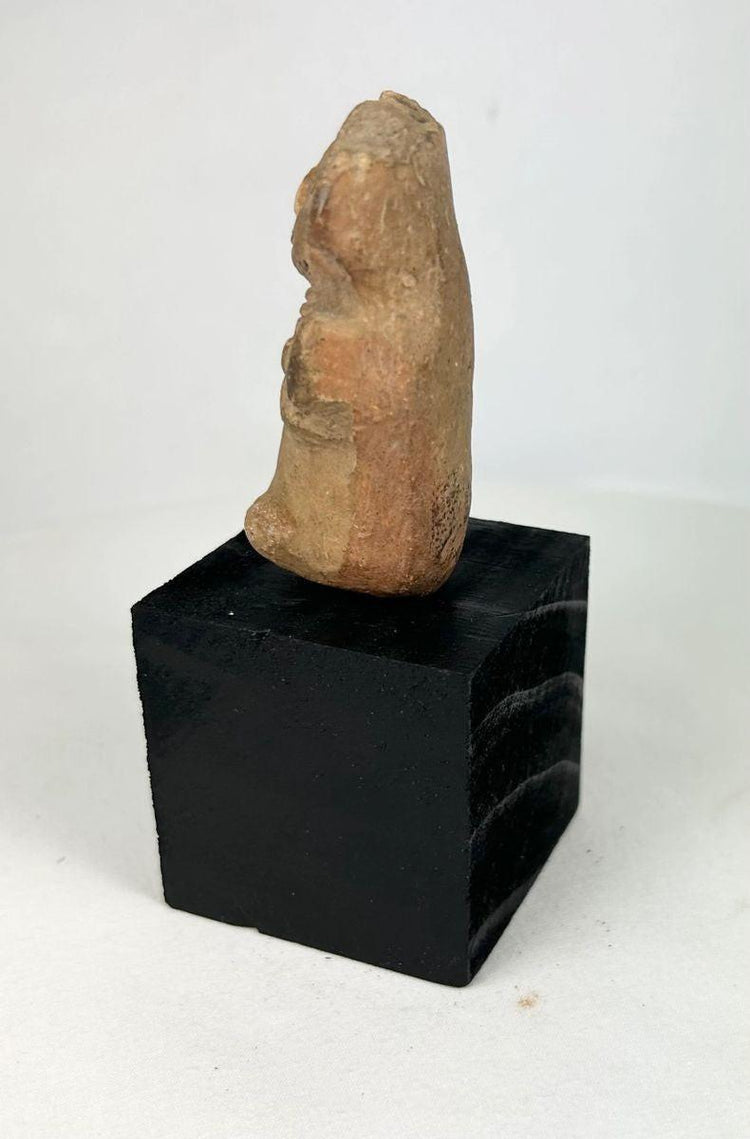Veracruz terracotta ritual figurine with stylized facial features and compact seated form
