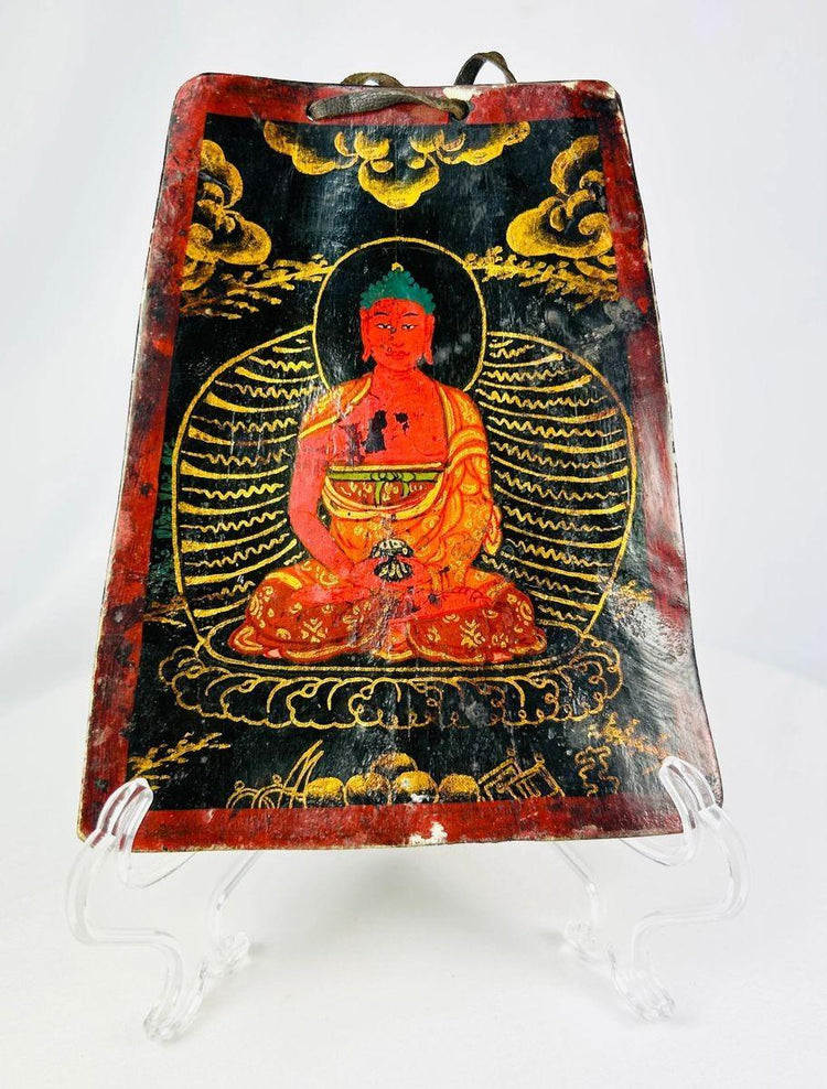 Detail of Tibetan Buddhist bone plaque showing Buddha in dhyana mudra with polychrome pigments