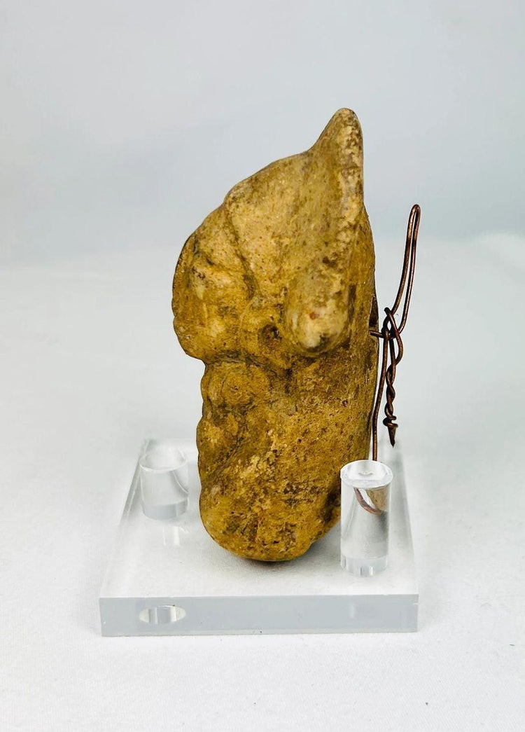 Ancient terracotta bust showing hand-molded facial features and ceremonial styling.