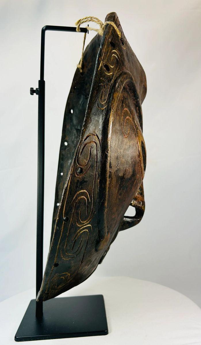 Hand-carved Sepik River ceremonial mask with bold facial features