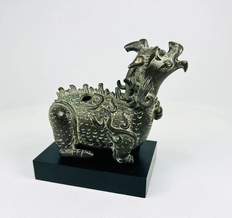 Qing Dynasty Qilin censer photographed at forward angle, highlighting sculpted horns, bulging eyes, and smoke-vent mouth.