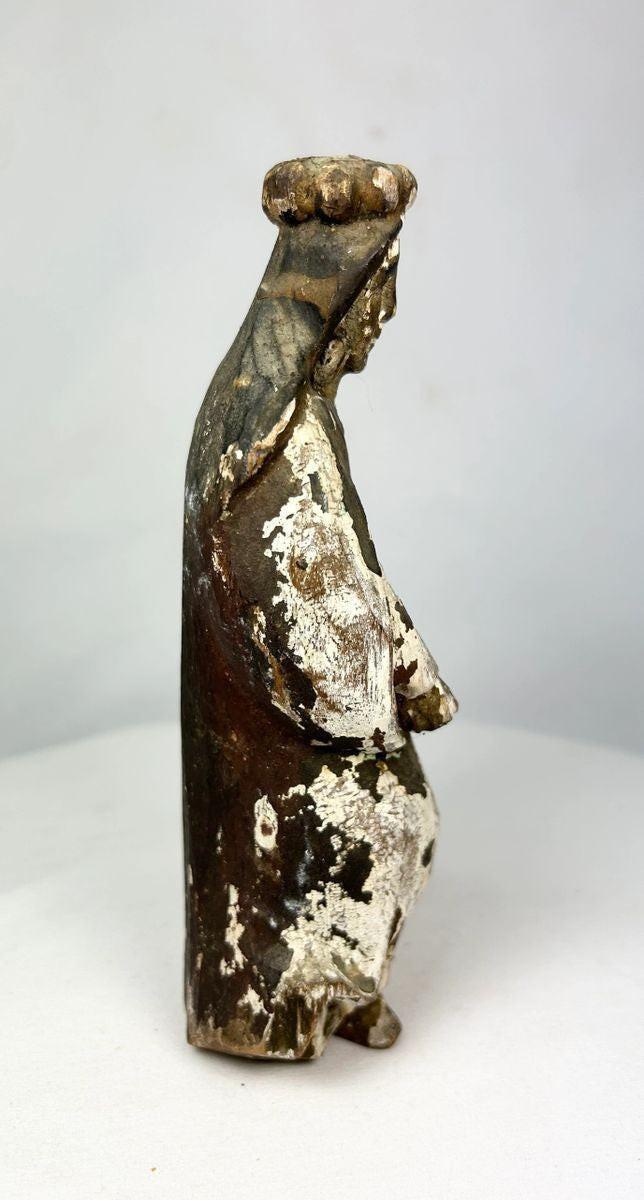 Ancient Spanish Colonial santo figure with worn gilding and polychrome remains, hand-carved wood statue on pedestal, 18th–19th century devotional artifact.