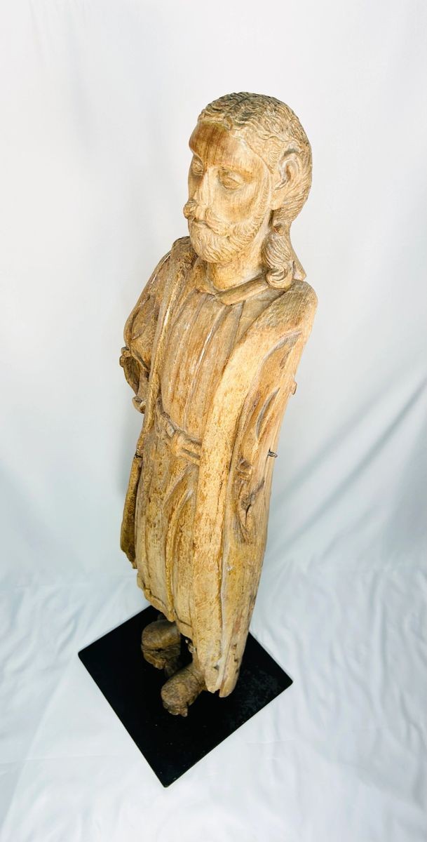 Antique European wood sculpture of saint, devotional church figure, medieval–Renaissance period, worn surface, detailed facial carving, mounted on custom iron stand for display.