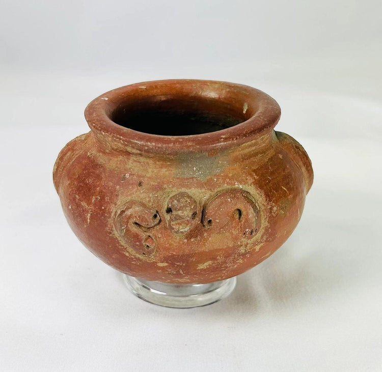 Ancient Pre-Columbian ceramic vessel in red terracotta with ornamental handles and aged patina