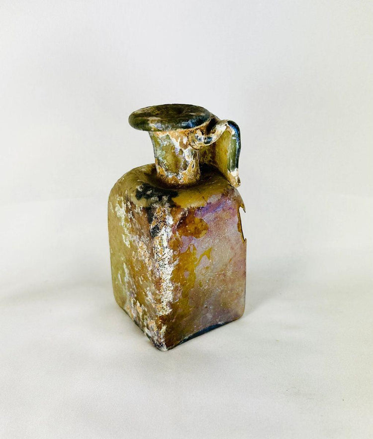 Historical Roman mold-blown glass bottle showcasing glassmaking innovation and age