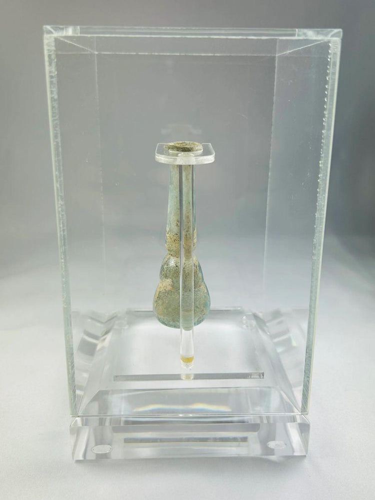 Ancient Roman pale turquoise glass balsamarium, 2nd–3rd century CE, outfolded lip, iridescent patina, luxury perfume container