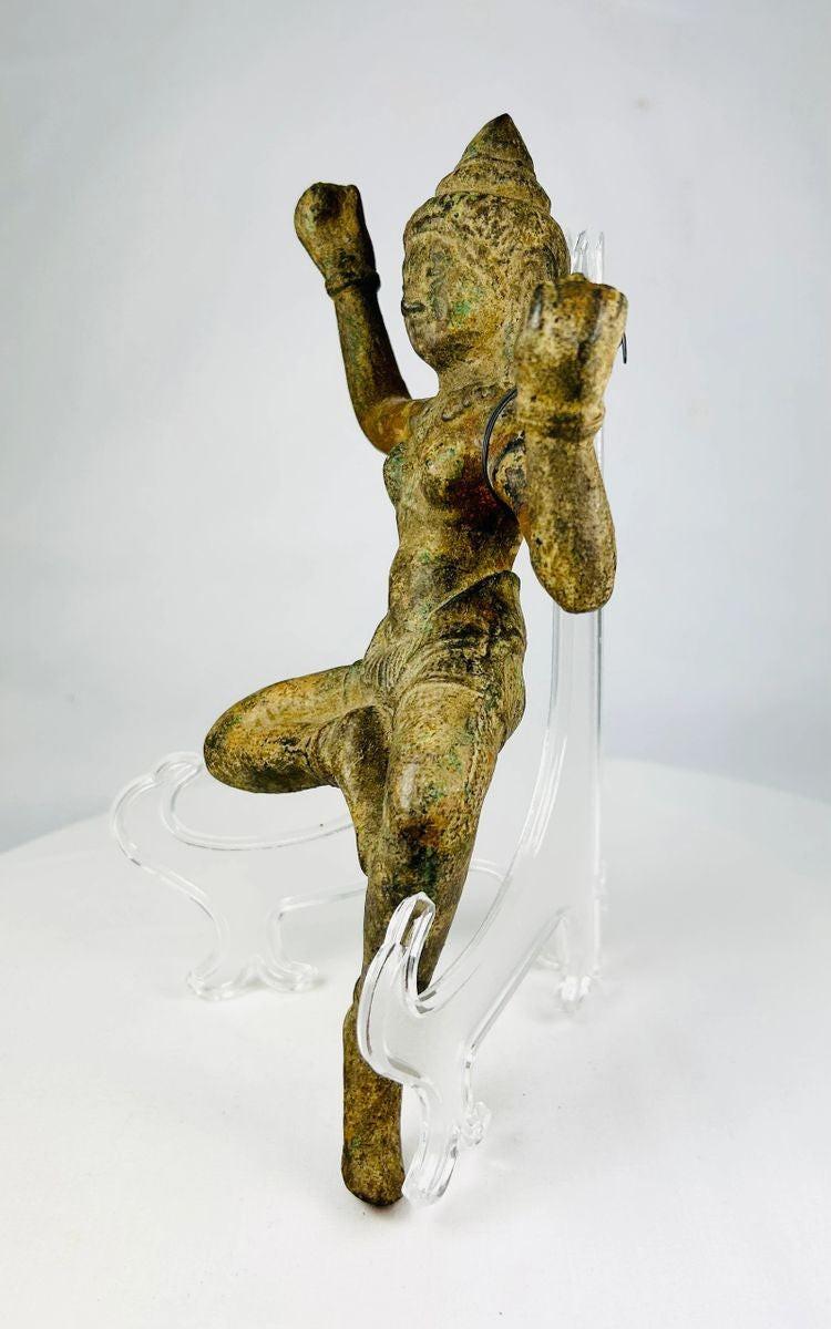 South Asian bronze sculpture featuring dancing deity with natural green patina