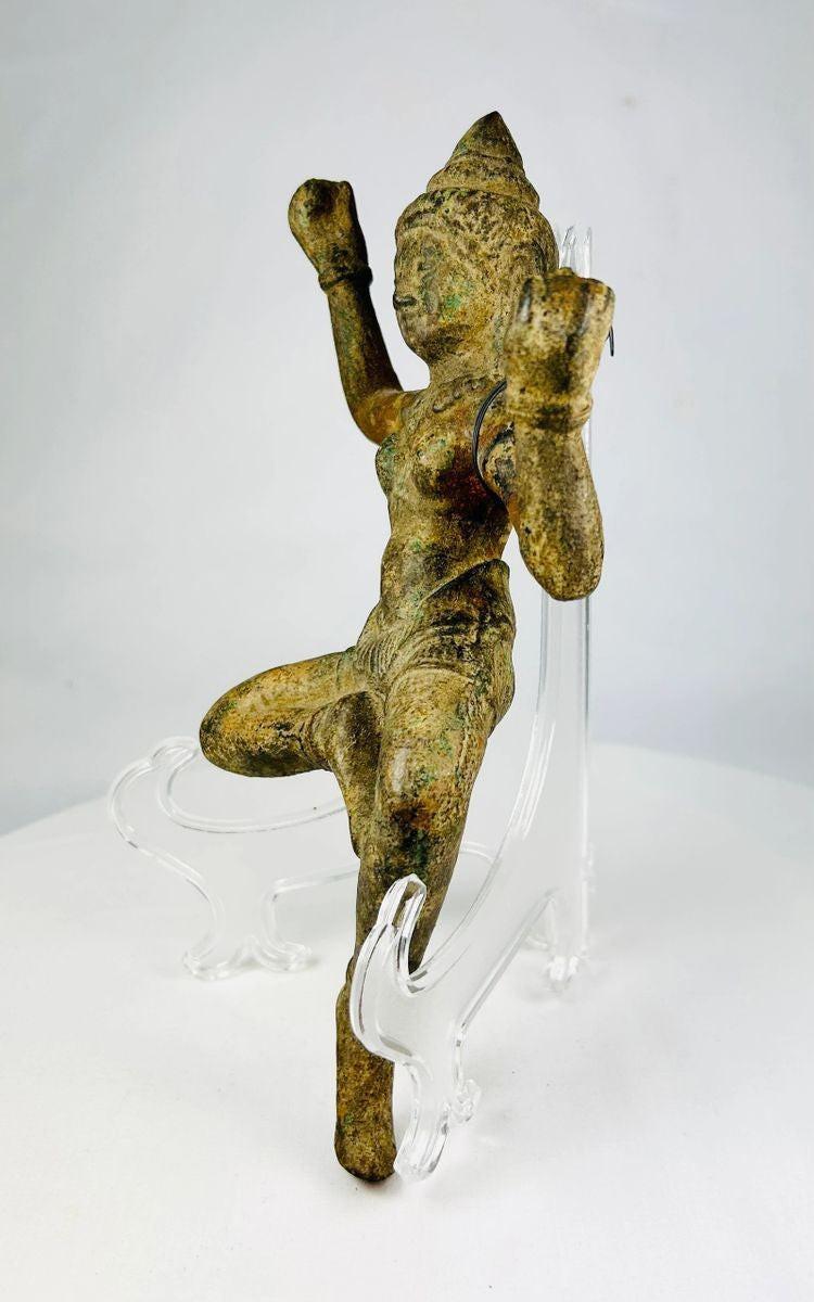 South Asian bronze sculpture featuring dancing deity with natural green patina