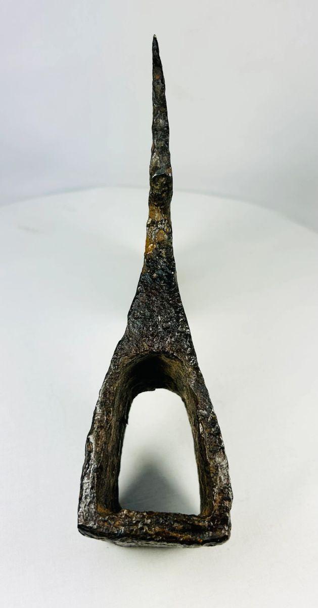 Antique medieval axe head with hollow socket and broad bearded blade