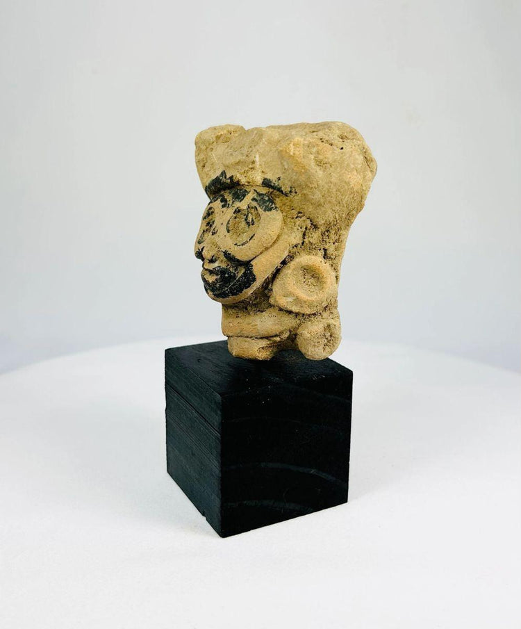 500–900 CE Mesoamerican head fragment mounted on display stand