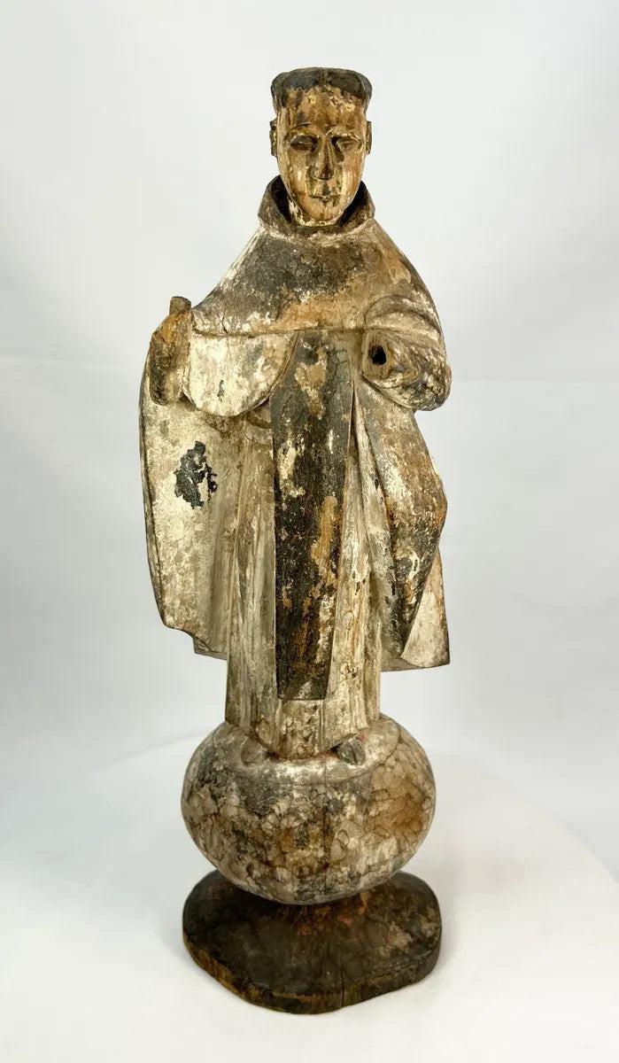 Colonial Latin American wooden santo depicting a monk or friar, with worn polychrome surface and centuries-old patina.