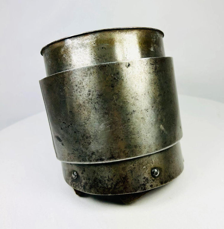 European Renaissance siege armor component showing overlapping cylindrical steel plates