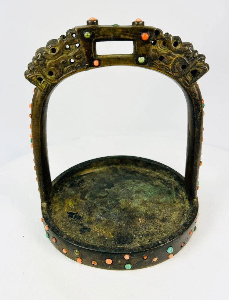 Historic 18th–19th century bronze stirrup with dragon-head terminals, photographed against white backdrop.
