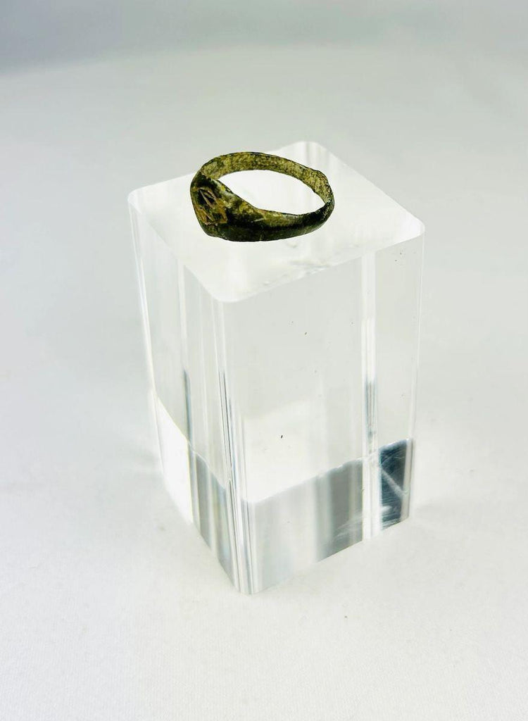 Side view of Roman bronze signet ring showing tapered band and aged patina.