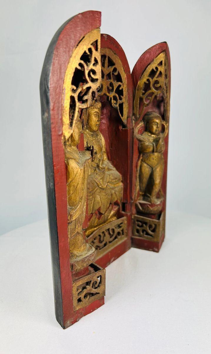 Museum-style display of a Qing Dynasty Chinese portable shrine with triptych doors