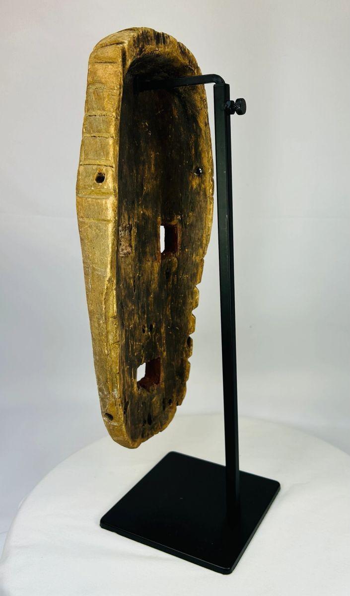 Handcrafted Sepik River tribal mask with red and white painted face