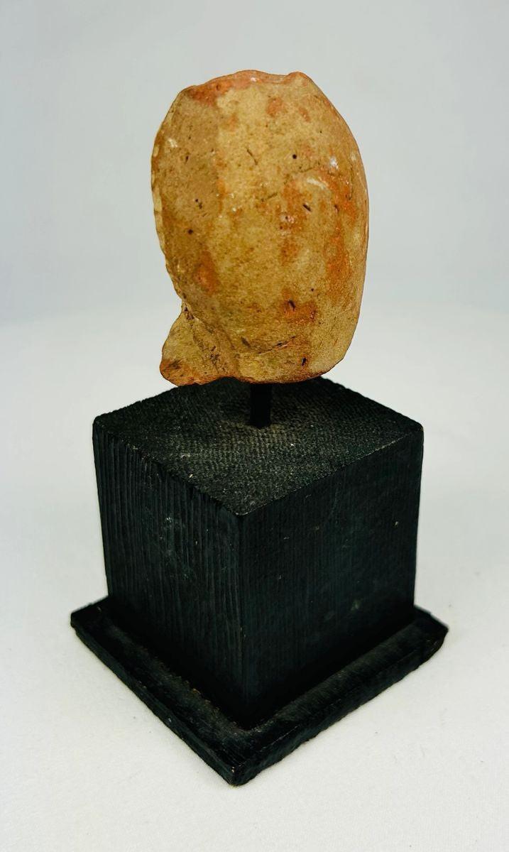 Weathered Pre-Columbian clay head fragment displaying ceremonial features