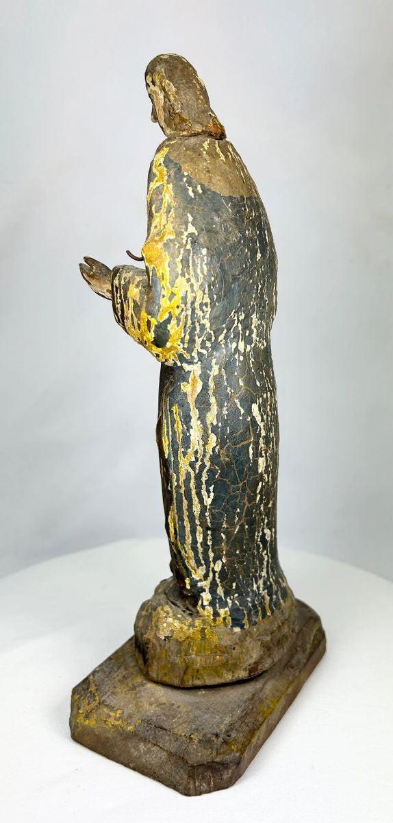 Rear view of an antique Spanish Colonial santo showing hand-carved wood grain and natural aging