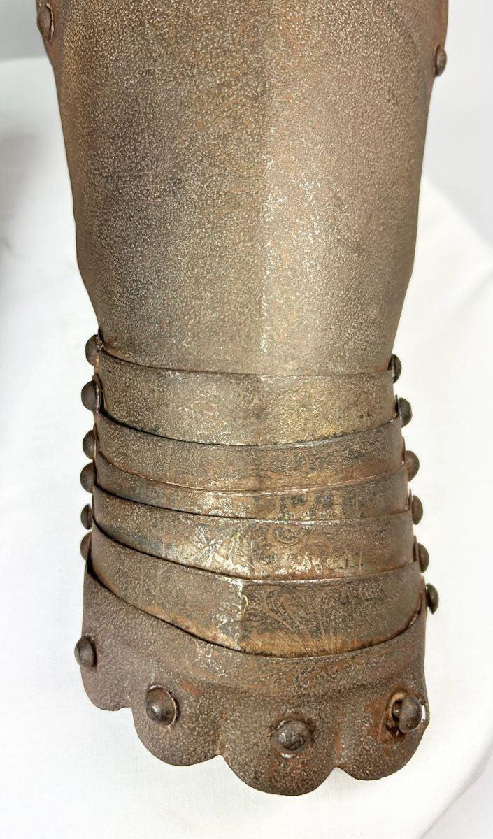 Close-up of articulation and engravings on Gothic-style steel gauntlets.