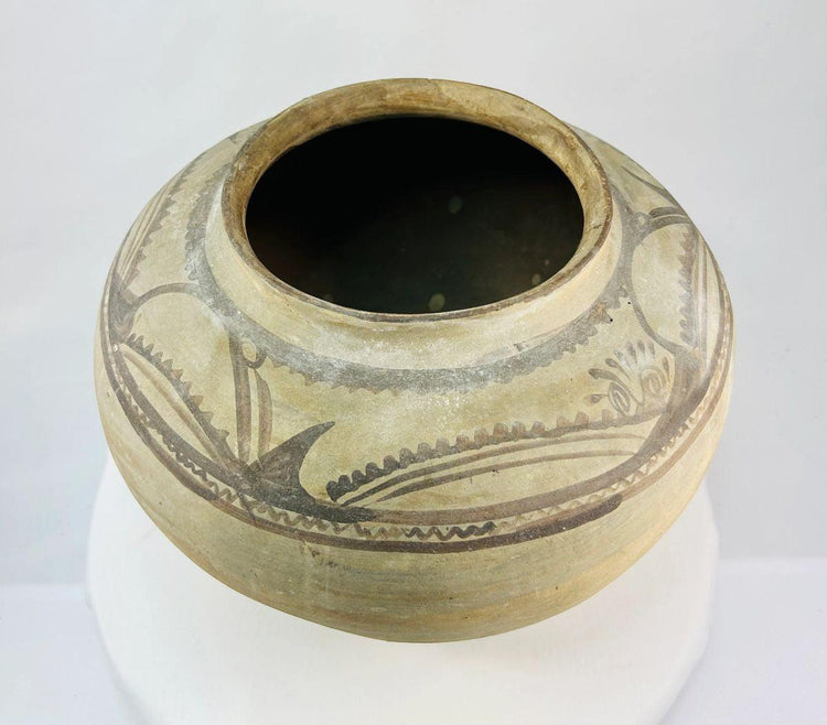 Top view of Neolithic pottery jar showing wide rim and interior opening.