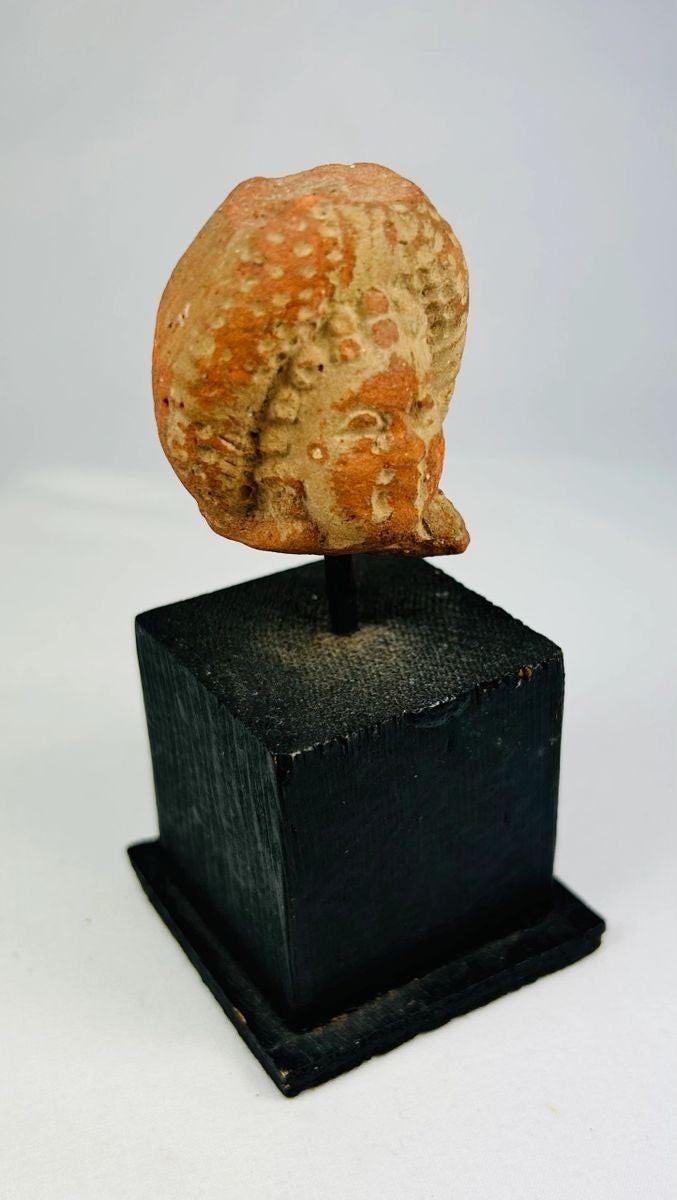 Pre-Columbian sculpted head fragment with natural patina and pigment traces