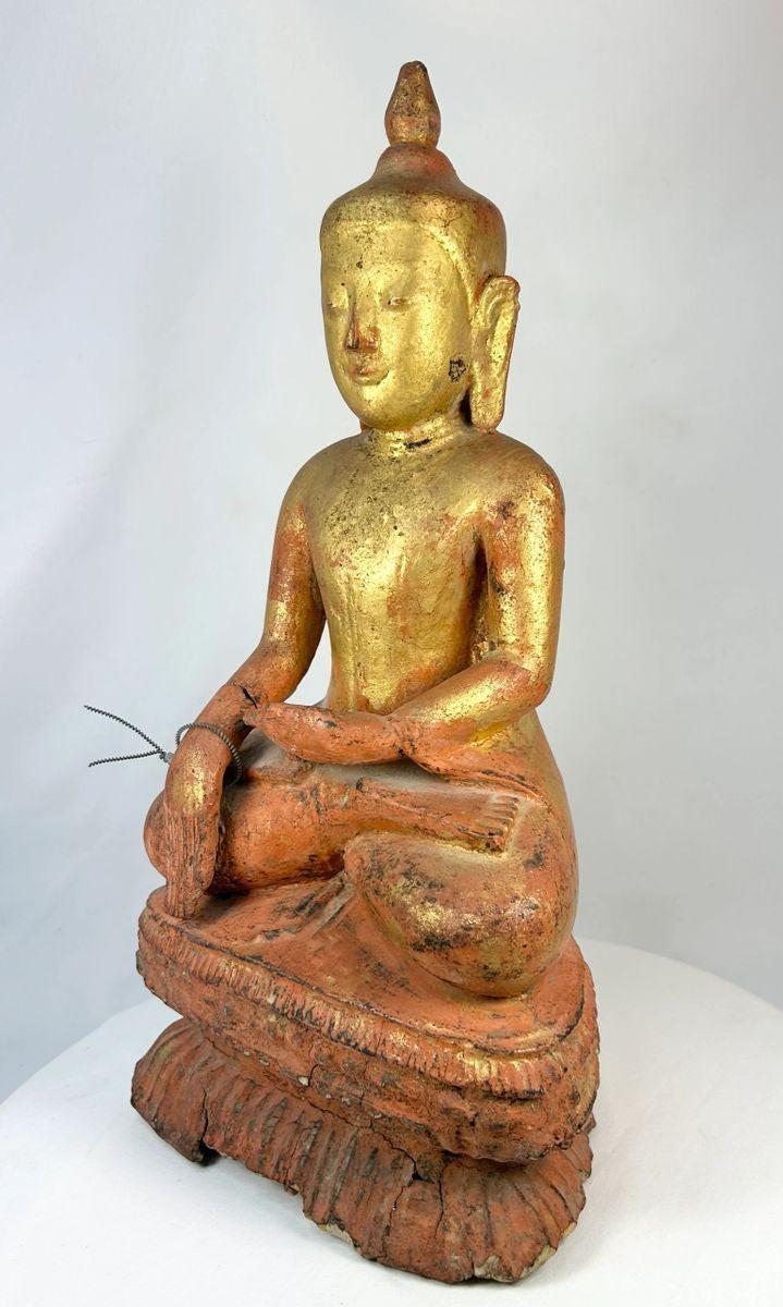 Antique Burmese monk statue with traces of gold gilding and red lacquer