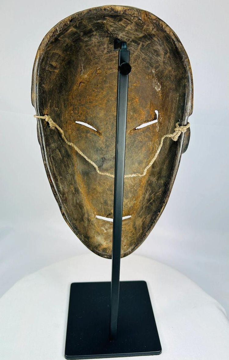 1930–1950 Dan tribal mask from West Africa with elongated eyes and patina