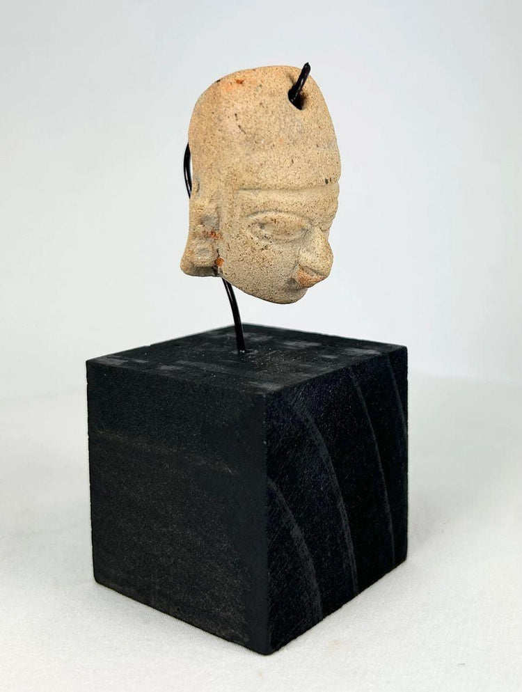Pre-Columbian terracotta head pendant with drilled suspension hole