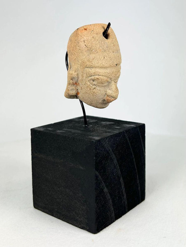 Pre-Columbian terracotta head pendant with drilled suspension hole